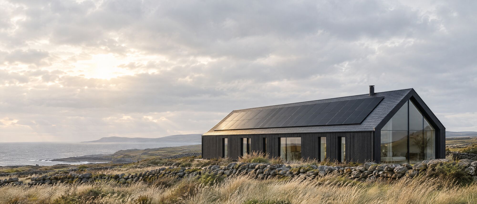 A contemporary home in the west of Ireland with a black solar array on a slate roof